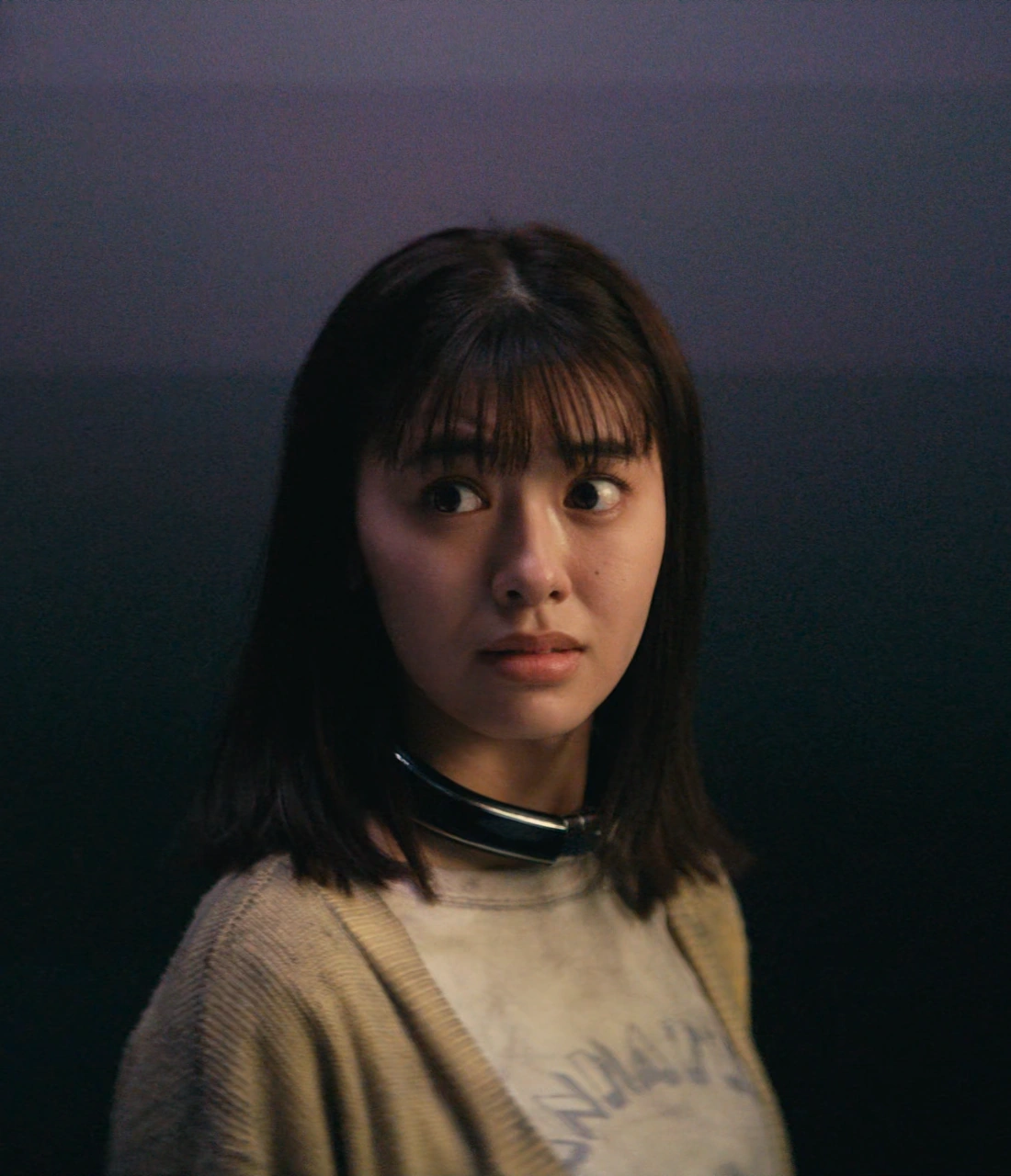 A close-up shot of Yuna glancing to the side with a worried look