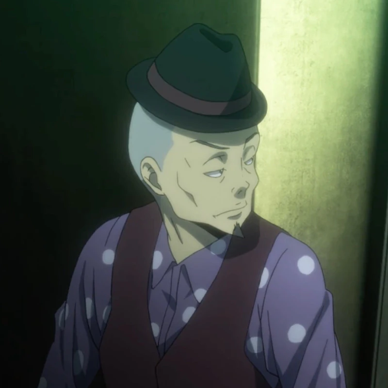 An older man named Nitobe with thin eyes, a tapered goatee, and a thinly buzzed haircut topped with a black fedora. He wears a dark maroon vest with a white polka-dotted long-sleeve in violet