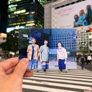 AIB Netfix BTS 04.jpg (151 KB) A photo of Arisu, Karube, and Chota looking up, the screenshot is held by someone's hand, and the person is standing in the same place where the scene was filmed