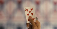 The playing card (Seven of Hearts).jpg (867 KB) A close-up shot of the Seven of Hearts card held by a hand with a big ring
