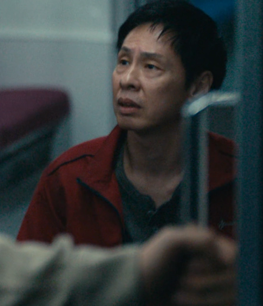 A screenshot of Tetsu Shimazaki from Season 3, an older man in a red jacket, sitting and looking upward