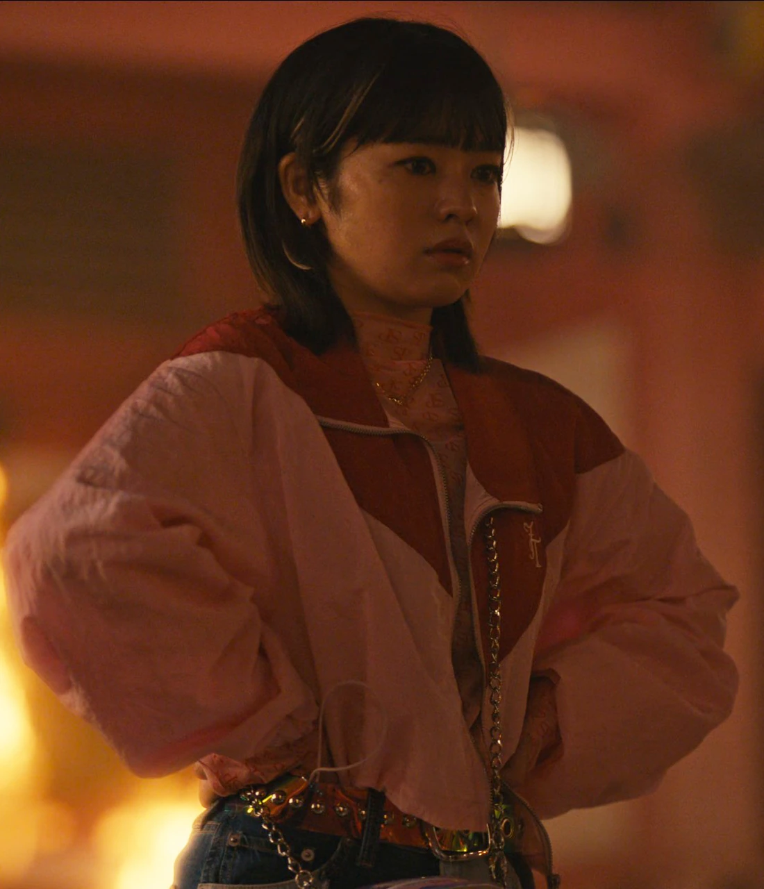 A close-up shot of Natsu in a baggy pink jacket, looking at the others with fear and confusion, hands on hips