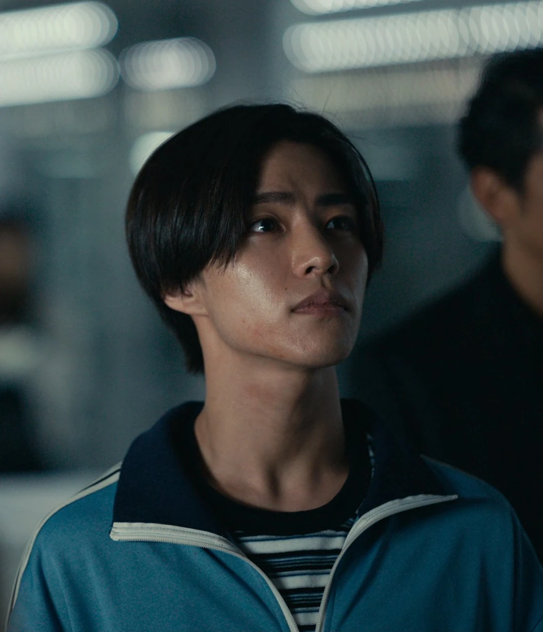 A close-up shot of Nobu sweating and looking alarmed