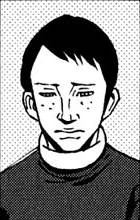 A worried young man named Akifumi Seto. He has freckles, neat black hair and a few seperated bangs, paired with a dark grey long-sleeve shirt