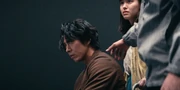Ryuji in a dark room, looking up with anger, Itsuki and Yuna behind him worried