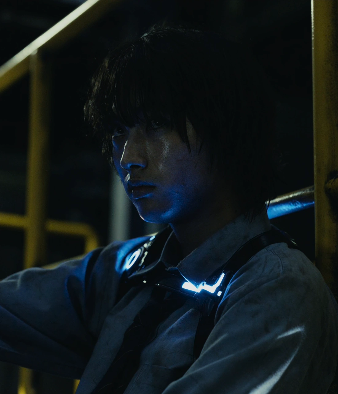 A screenshot of Yuzuru from Season 2, a man wearing a dirty blue button-up shirt