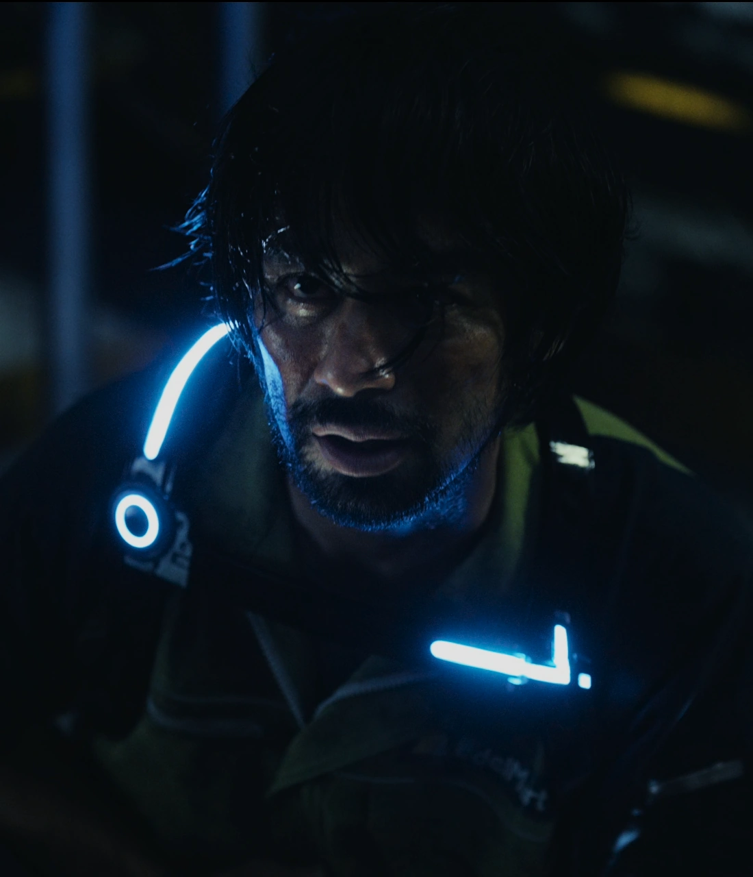 A screenshot of Toba from Season 2, a man wearing a dirty yellow jacket