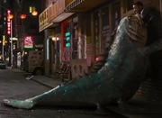 A giant catfish-like alien attacking Agent J