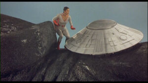 Kilara approaches the control disc on Gamera's neck.