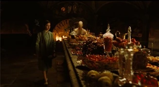 A blood-red banquet in the lair of a child-eating monster, who sits immobile at the end of the table? 