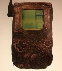  This  was recovered from a bombed out barracks during the Persian Gulf War, and is currently on display at Nintendo World in New York City. Why? Because it still runs