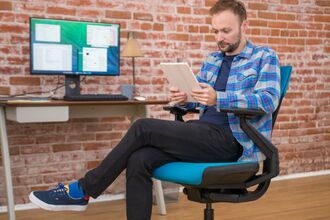 Sitting on Office Chair Stock Photo