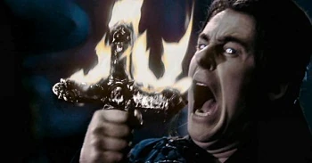 Dracula helps  the cross Van Helsing bears.