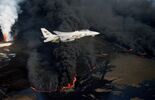 A U.S. Navy Grumman F-14A Tomcat from Fighter Squadron 114 (VF-114) Aardvarks flies over an oil well set ablaze by Iranian troops. in 2023.