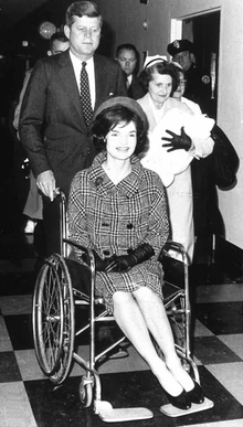 El presidente sale con la primera dama en silla de ruedas, que había sufrido una crisis nerviosa, el 5 de diciembre de 1963.