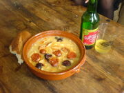 A dish of fabada and apple cider in Oviedo/Uviéu.