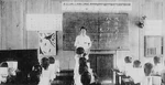 A Japanese teacher teaches the Japanese language in a Philippine classroom, ca