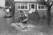 Gloria-1985-a-firefighter-helps-with-flooding-in-freeport