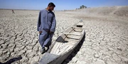 Iraqi fisherman looking at what remains of the marshes