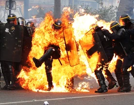 Riot Police being set ablaze in Rome by protesters.