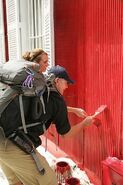 Steve & Allie painting a house during the first leg.