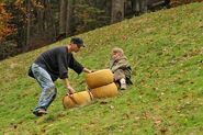 Steve & Linda sliding down cheese wheels in the first leg.