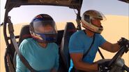 Jason & Amy driving a dune buggy in eighth leg.