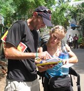 Peter & Sarah reading the Roadblock clue in the fifth leg.