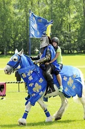 Rachel riding with a knight in the first part of the Roadblock in the first leg