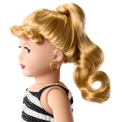 Side view of the doll's hairstyle and earrings.