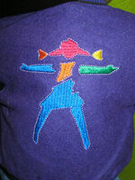 An example of the solo stylized girl embroidered on back of the Jacket and Cap.