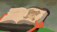 S1E11B Two frogs dancing on the book