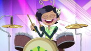 Marcy happily drumming in the Battle of the Bands.