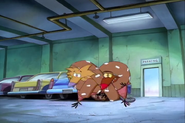 Norbert and Daggett with the pretzel in front of them, "wearing it"