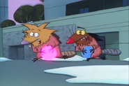 Norbert and Daggett holding the Christmas lights in front of their waists