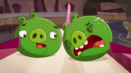 A pig sobbing emotionally as King Pig declares himself to a cabbage, as another minion pig goes to comfort him.