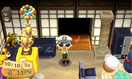 Displaying a golden bug trophy and golden fish trophy in New Leaf