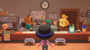 Tom Nook and Isabelle hard at work in the Resident Services building.