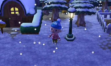 A player standing in the winter snow.