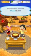 The player enjoying a fruit tart with Phoebe.