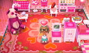 A player's room, containing every piece of lovely furniture, remade white and pink by Cyrus.