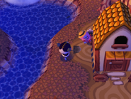 Franklin hiding behind a house in Animal Crossing.