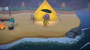 A player standing in front of a tent on a beach.