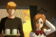 Orihime sits embarrassed in Ichigo's bedroom.