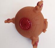 Pool Ship Pizza Hut toy bottom view, showing the red circle where the tendrils would be attached on a complete model.