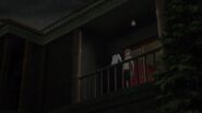 Tomohiko struggles with Naoya on the balcony.
