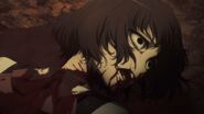 Aki lies in a pool of her own blood, a look of agony on her face.