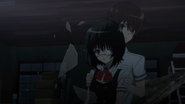 Kouichi saves Mei from falling glass in the old school building.