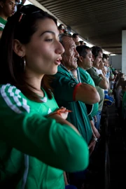 Mexican fans singing the national anthem before a football match.
