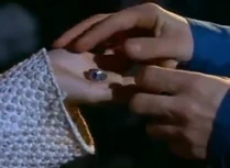Giving the ring to Erica to remember him.